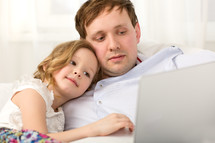 Father and little daughter using laptop