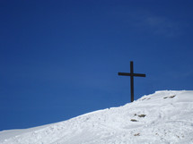 Cross on a snow-covered mountain top, 
