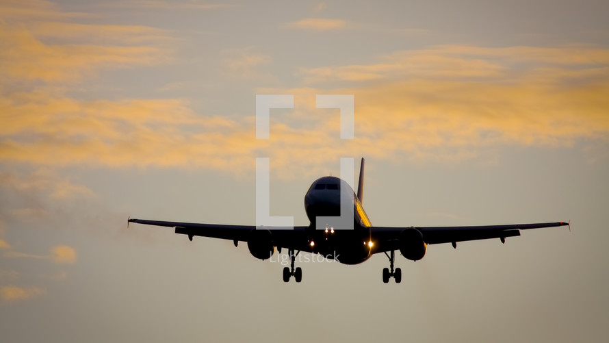 plane landing at sunset 