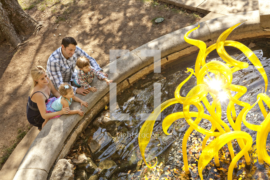 A young family by a water fountain