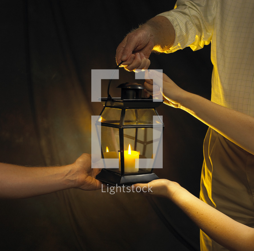 hands on a candle lantern 