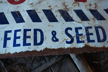 Old, trashed Feed and Seed sign