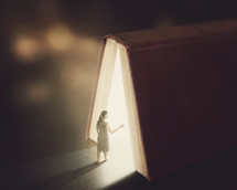 woman entering the light of a Bible 