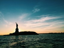 Statue of Liberty silhouette at sunset 