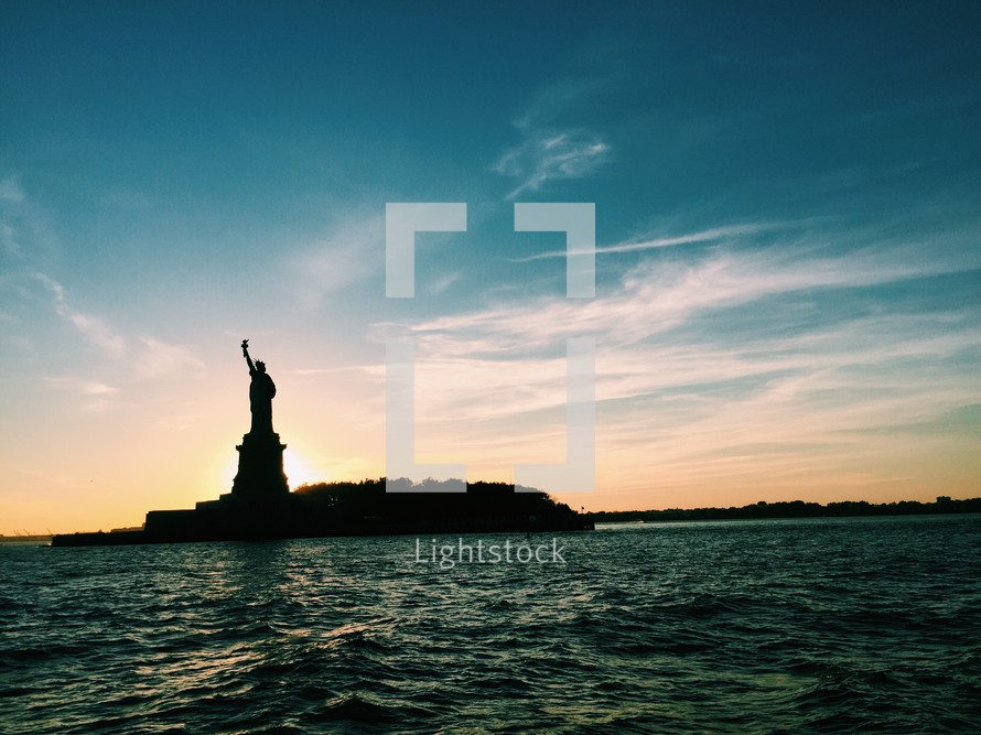 Statue of Liberty silhouette at sunset 