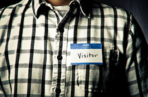 Man wearing "Visitor" name tag