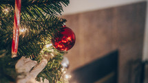 ornaments on a Christmas tree and fireplace view 
