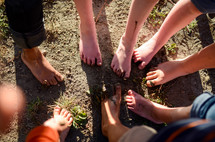 children's dirty feet in mud 