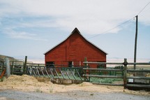 red barn and feeding area and fence 