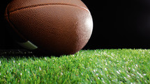 close up of a football ball on the grass