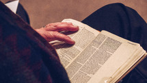 elderly person reading a Bible 