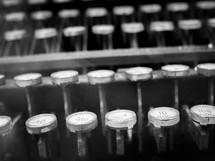 a black and white shot of old typewriter keys