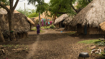 a woman walking through a village 