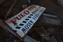Old, broken Feed and Seed sign
