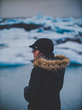 a woman looking out at icebergs