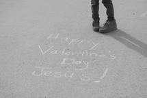 A little girl standing next to the words Happy Valentine's Day Jesus
