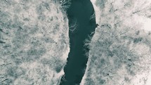 aerial view over a river and winter landscape 