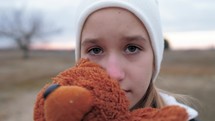 Sad depressed girl with teddy bear. Childhood. Education. Problem. Sad little girl and her teddy bear. Sad little girl feels lonely.