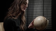 Fashion Model posing with a globe map 
