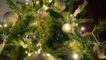Christmas tree adorned with silver and white balls and lights