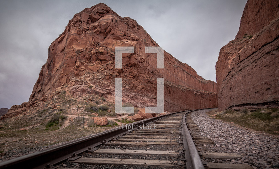 train tracks through a red rock canyon