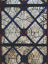 red, blue, and white patterned stained glass window 