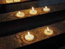Candles lit by worshippers in a Christian church