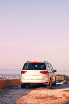 A car parked at the top of a viewpoint 