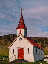 red steeple on a white church 