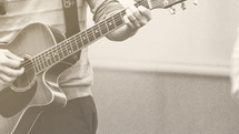 man's hands on a guitar 
