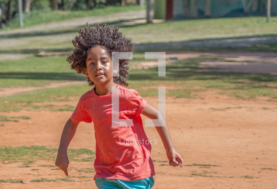 a little boy running outdoors 