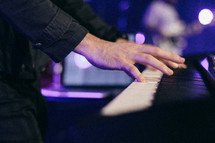 Hands on a piano.