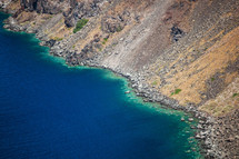 volcanic mountains and turquoise water in Santorini island, Greece