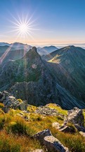 Vertical time lapse of Sunset over rocky alps mountains in autumn evening nature at golden hour
