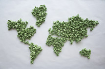 world map made with crumpled green pieces of paper. 