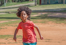 a little boy running outdoors 