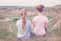 girls sitting outdoors enjoying the view 