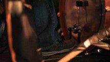 Dolly shot of a drummer's foot playing the bass drum