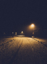 glow of street lamps at night on snow 