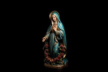 Statue of the Virgin Mary on a black background. Isolated