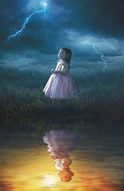 A little girl looking up at a rain storm while her reflection is in warm sunlight