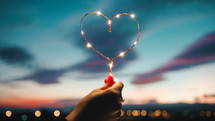 Holding A Heart Of Fairy Lights