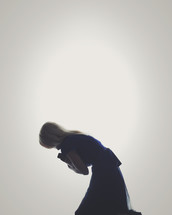a kneeling woman praying 