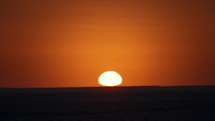 Sunrise over the horizon at the Sahara desert