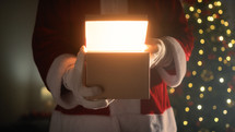 Santa claus opening a magical Christmas box 