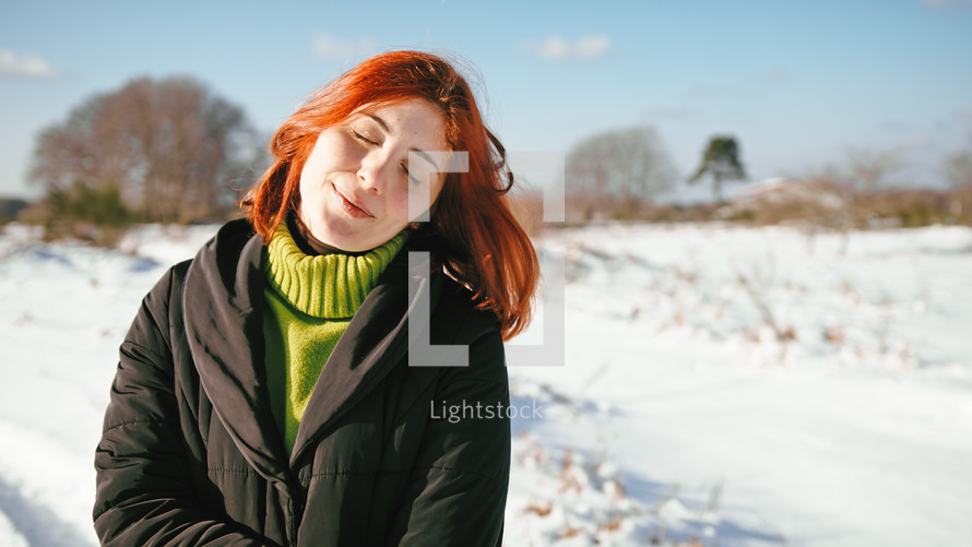 Woman under the sun in the snowy mountain