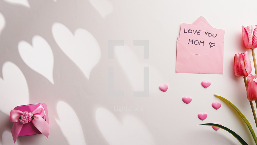 Mother's Day. Colorful flat lay background with tulips, hearts, and a gift.
