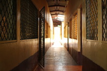 gate and barred windows in a long hall 