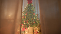 Christmas Tree hidden behind a house curtain