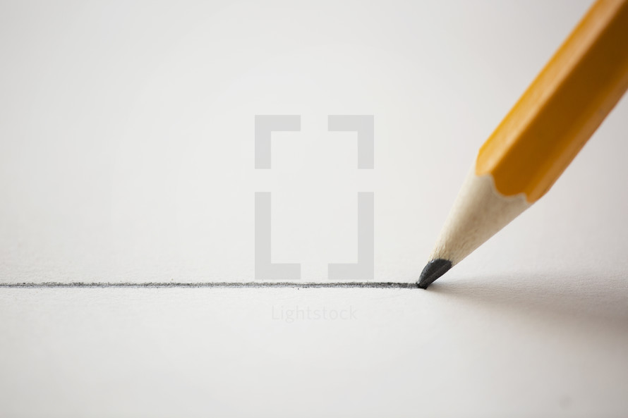pencil drawing a straight line on a piece of paper. 